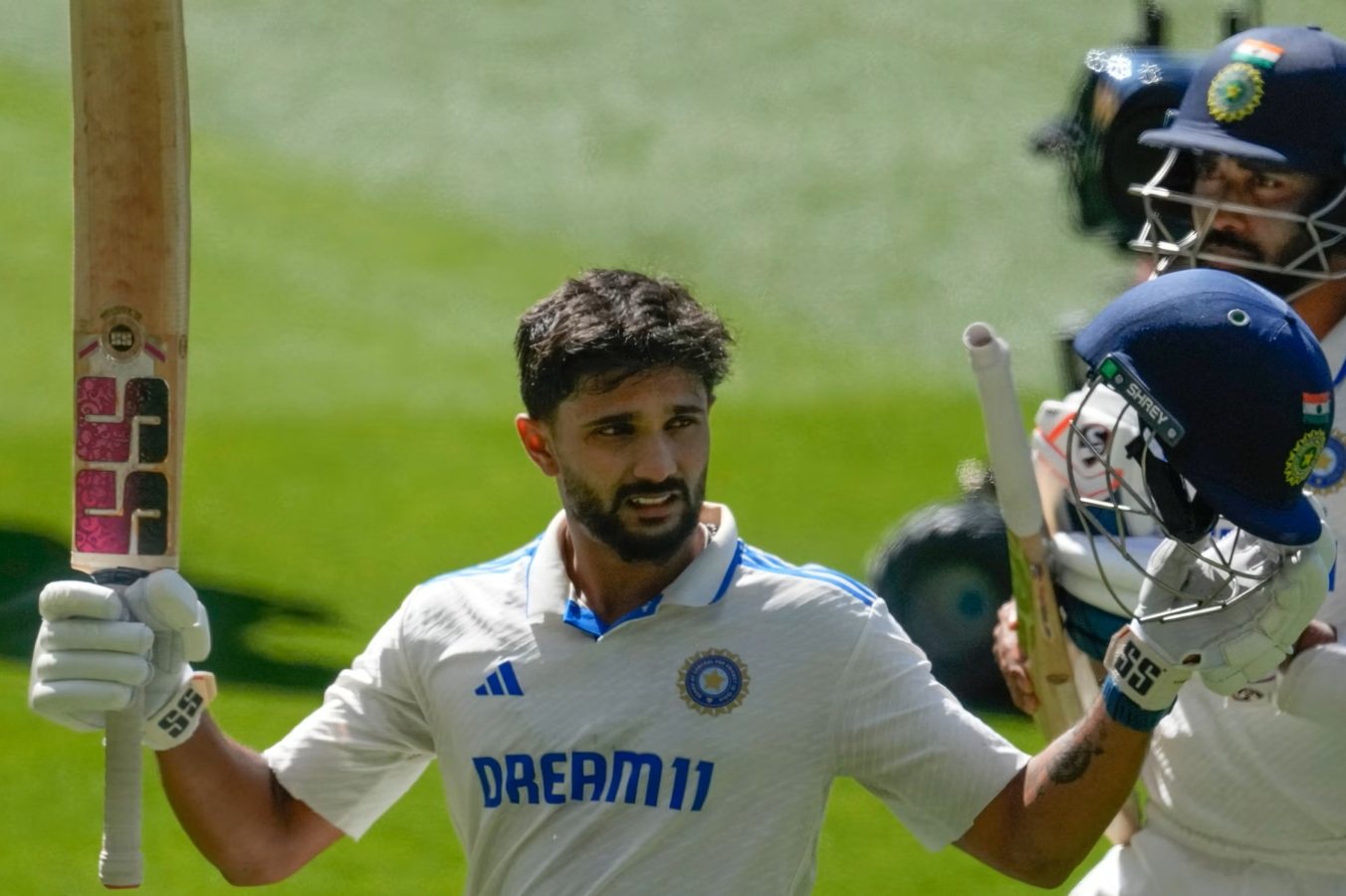 A cricketer showcasing a premium English Willow bat during a Test match.